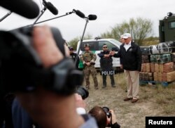 U.S. President Donald Trump talks to the media as he stands with U.S. Border Patrol agents on the banks of the Rio Grande River during his visit to the U.S.-Mexico border in Mission, Texas, Jan. 10, 2019.