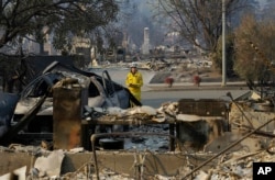 A California Fire Department forester inspects damage at homes destroyed by fires in Santa Rosa, California, Oct. 12, 2017.