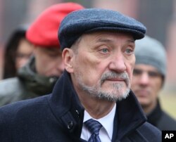 Polish Defense Minister Antoni Macierewicz watches members of paramilitary defense brigades practicing in Minsk Mazowiecki, Poland, Nov. 6, 2016.