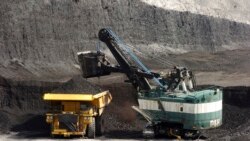 FILE - A mechanized shovel loads a haul truck with coal at the Spring Creek coal mine near Decker, Mont., April 4, 2013. A federal judge in Montana says the Trump administration failed to consider the environmental effects of resuming coal sales from fede