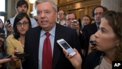 FILE - Sen. Lindsey Graham, R-S.C. is surrounded by reporters as he arrives at the Senate on Capitol Hill in Washington, July 27, 2017.