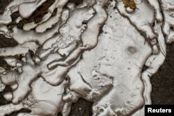 Melted metal from an abandoned car destroyed by the Camp Fire is seen in Paradise, California, U.S., Nov. 10, 2018.