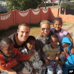Study abroad students Ben Valerio and Hillary Kinsey at the Siyazingcy Creche, a daycare center in South Africa.