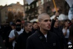 FILE - Members of nationalist movements attend a rally marking Defender of Ukraine Day, in Kyiv, Ukraine, Oct. 14, 2018.