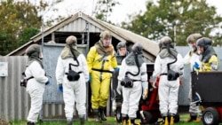 Employees from the Danish Veterinary and Food Administration and the Danish Emergency Management Agency in protective equipment are seen amid the coronavirus disease (COVID-19) outbreak at a mink farm in Gjoel, North Jutland, Denmark October 8, 2020.
