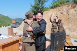 North Korean leader Kim Jong Un reacts with scientists and technicians of the DPRK Academy of Defence Science after the test-launch of the intercontinental ballistic missile Hwasong-14 in this undated photo released by North Korea's Korean Central News Agency, July 5, 2017.