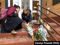 Two young girls light candles at a memorial on Oct. 29, 2018, in front of the Jewish Community Center of Greater Pittsburgh, one of the sites chosen for the first day of funerals.