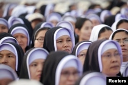 Catholic faithful attend a mass led by Pope Francis at Kyite Ka San Football Stadium in Yangon, Myanmar, Nov. 29, 2017.