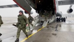 A still image from video released by Russia's Defence Ministry shows Russian service members disembarking from a military aircraft, at an airfield in Kazakhstan, Jan. 7, 2022.