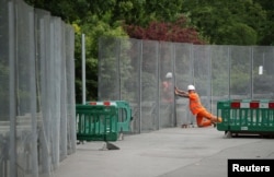 Workmen construct fences ahead of the U.S. presidential visit, around the U.S. ambassador's residence in Regent's Park in London, May 31, 2019.