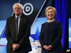 Democratic presidential candidates, Hillary Clinton and Sen. Bernie Sanders, I-Vt, stand together before the start of the Univision, Washington Post Democratic presidential debate at Miami-Dade College, March 9, 2016.