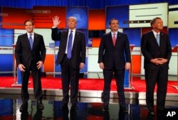 Republican presidential candidates, Sen. Marco Rubio, R-Fla., businessman Donald Trump, Sen. Ted Cruz, R-Texas, and Ohio Gov. John Kasich take the stage before a Republican presidential primary debate at Fox Theatre in Detroit, March 3, 2016.