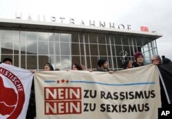 People protest in front of the main station in Cologne, Germany, Jan. 6, 2016.