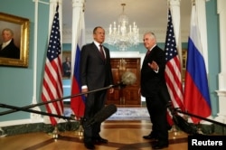 U.S. Secretary of State Rex Tillerson (R) waves to the media next to Russian Foreign Minister Sergey Lavrov before their meeting at the State Department in Washington, May 10, 2017.
