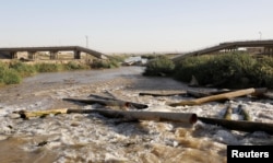 FILE - A bridge destroyed by an U.S. air strike is pictured in the outskirts east of Raqqa, Syria, Oct. 5, 2017.