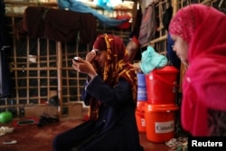 Formin Akter applies makeup before heading to Chittagong to attend school at the Asian University for Women in Cox's Bazar, Bangladesh, Aug. 24, 2018.