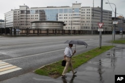 FILE - A man walks past the building of the Russian military intelligence service in Moscow, Russia, July 14, 2018.