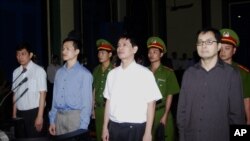 FILE - From left to right : Tran Huynh Duy Thuc, Nguyen Tien Trung, Le Thang Long and Le Cong Dinh listen to the verdict at a court in Ho Chi Minh City, Jan. 20, 2010.