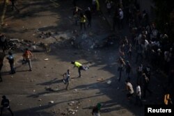 Demonstrators protest following a rally against the government of Venezuela's President Nicolas Maduro and to commemorate May Day in Caracas, May 1, 2019.
