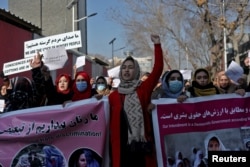 FILE - Afghan women shout slogans during a rally to protest Taliban restrictions on women, in Kabul, Afghanistan, Dec. 28, 2021.