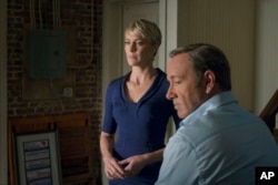 FILE - This image released by Netflix shows Robin Wright as Claire Underwood, left, and Kevin Spacey as Francis Underwood in a scene from "House of Cards."