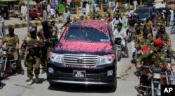 A vehicle carrying Syed Salahuddin, the top leader of the Hizbul Mujahideen, is escorted by his supporters, arrives for a press conference in Muzaffarabad, the capital of Pakistani controlled Kashmir, Saturday, July 1, 2017.