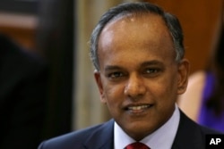 FILE - Singapore's Minister for Foreign Affairs and Law K. Shanmugam poses for photographs before a dinner with U. S. Secretary of State Hillary Rodham Clinton at the Ministry of Foreign Affairs, Nov. 16, 2012.