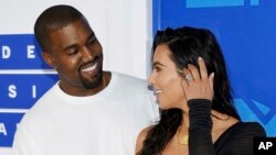 FILE - In this Aug. 28, 2016 file photo, Kanye West, left, and Kim Kardashian West arrive at the MTV Video Music Awards in New York.