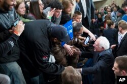 Democratic presidential candidate Sen. Bernie Sanders, I-Vt., shakes hands during a United Auto Workers rally in Dearborn, Michigan, Feb. 16, 2016.