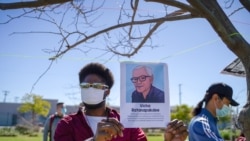 An African-American holding a portrait picture of Vicha Ratanapakdee during the Asian American event to raise awareness about the increase in hate crimes against Asians in the US near Chinatown Los Angeles, CA.