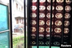 FILE - Negatives showing the lungs of Wang Zhaohong, who suffers from silicosis, hang on the window of Wang's room in Sangzhi county, Hunan province, China, Nov. 27, 2018.