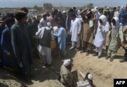 Afghan mourners gather at a burial ceremony for nine people killed during an overnight raid by Afghan forces in Chaparhar district on the outskirts of Jalalabad in Nangarhar province on May 29, 2018.