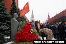 RUSSIA -- A woman bows her head to the bust of Soviet leader Joseph Stalin during a ceremony marking the 66th anniversary of his death, in Red Square, Moscow, Russia March 5, 2019