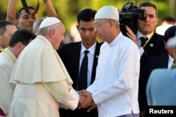 Pope Francis shakes hands with Myanmar's President Htin Kyaw as he arrives at Presidential Palace in Naypyitaw, Myanmar, Nov. 28, 2017.