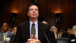 FILE - FBI Director James Comey prepares to testify on Capitol Hill in Washington, May 3, 2017.
