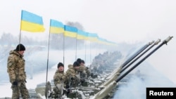 Ukrainian servicemen are seen atop armored personnel carriers (APCs) at a firing range outside Zhytomyr, Jan. 5, 2015.