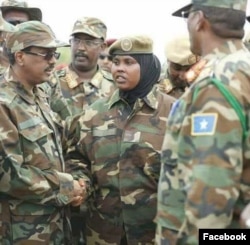 Col. Faadumo Ali is seen shaking a fellow soldier's hand in a undated social media photo (Facebook - Faay Cali Raage).