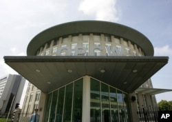 FILE - A security guard is seen at the OPCW headquarters in The Hague, Netherlands, May 9, 2007.