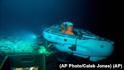 The Pisces IV submersible sits on top of Cook seamount, as seen from the Pisces V craft, during a dive to the previously unexplored underwater volcano off the coast of Hawaii's Big Island on Sept. 6, 2016. Seamounts are places scientists are finding new species. (AP Photo/Caleb Jones)