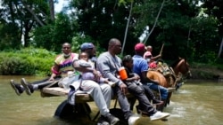 Migrants cross the Acandi River on a horse cart in Acandi, Colombia, Sept. 14, 2021.