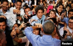 President Barack Obama shakes hands after holding a town hall meeting with young leaders at Pontifical Catholic University of Peru in Lima, Nov. 19, 2016.