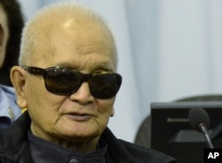 In this photo released Cambodia's war crimes court, Khmer Rouge leader Nuon Chea listens to testimony during his trial in Phnom Penh, Mar. 20, 2012.