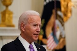 President Joe Biden speaks about the coronavirus in the State Dinning Room of the White House, Thursday, Jan. 21, 2021, in Washington. (AP Photo/Alex Brandon)