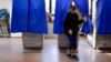 FILE - A voter leaves a polling booth during the U.S. presidential election in Philadelphia, Pennsylvania, Nov. 8, 2016.