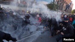 Police officers and Catalan separatists clash during a rally in Barcelona, Spain, Nov. 10, 2018.