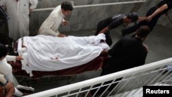 Hospital staff and relatives shift Sumbal, a female worker of an anti-polio drive campaign who was shot by unidentified gunmen, to the intensive care ward at a hospital in Peshawar May 28, 2013. 