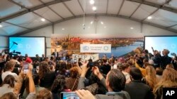 FILE - Youth and indigenous groups protest against fossil fuels during US-hosted event at the UN climate talks in Katowice, Poland, Dec. 10, 2018, as the COP24 UN Climate Change Conference takes place in the city. 