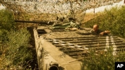 FILE - A Ukrainian government soldier looks toward pro-Russia rebel positions near Avdiivka, outside Donetsk, eastern Ukraine, Aug. 24, 2015.