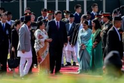 FILE - China's President Xi Jinping and Nepal's President Bidhya Devi Bhandari arrive at Tribhuvan International Airport, as Xi wraps up his two-day visit to Nepal, in Kathmandu on Oct. 13, 2019. (Prakash Mathema/Pool via Reuters)