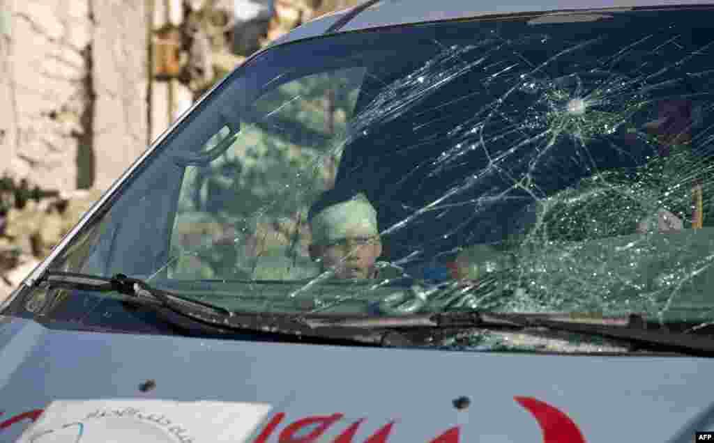 A wounded boy sits inside an ambulance as Syrian rebels and their families gather at the rebel-held al-Amiriyah neighborhood as they wait to be evacuated to the government-controlled area of Ramoussa on the southern outskirts of the city on Dec. 15, 2016.